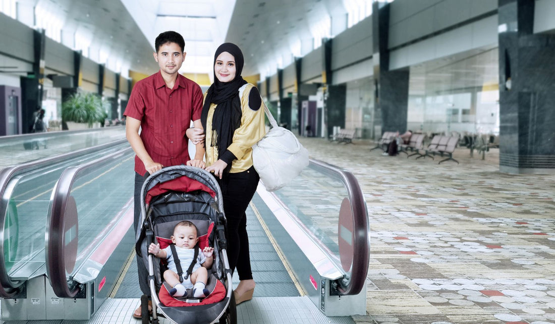 man next to a women with a child in a stroller at the airport