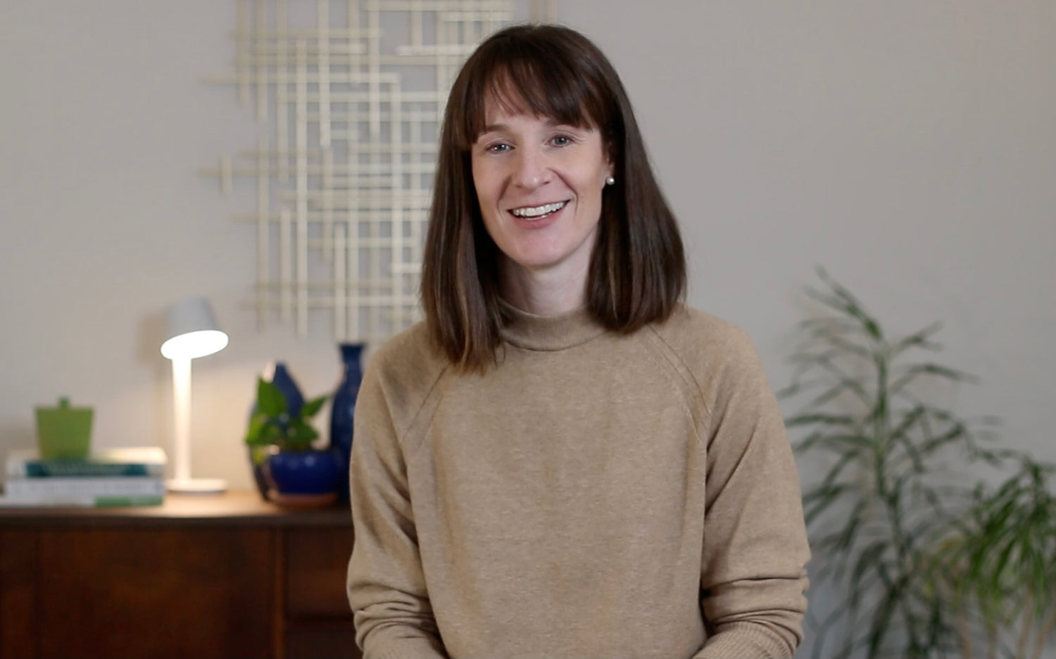 Women with brown sweater smiling