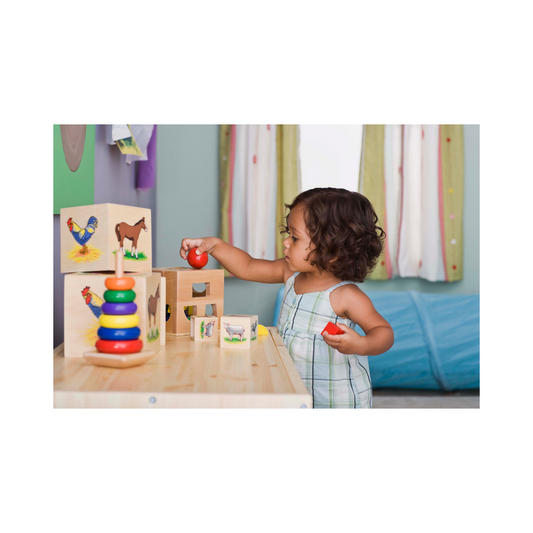 Girl playing with wooden toys. The toys are quiet toys.